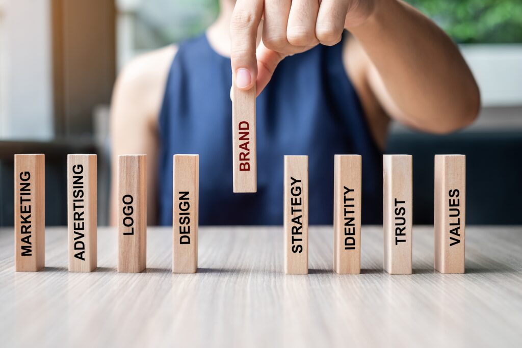 Branding a New Business | Businesswoman hand placing or pulling wooden Dominoes. Business, Risk Management, Solution and strategy Concepts